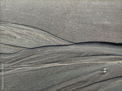 texture of sand of wet beach sand with former water flow