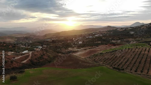 4K sunset drone footage over beautiful houses, fields and mountains at Abdalajis valley, Antequera, Malaga, Spain.
Mid angle, parallax movement.