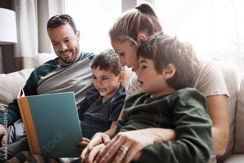 Relax, children and parents reading a book for bonding, fun and quality time. Knowledge, information and boys excited about learning a story together on the lounge sofa with their mother and father © Reese/peopleimages.com
