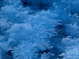Close up of dark blue frosty pattern on ice