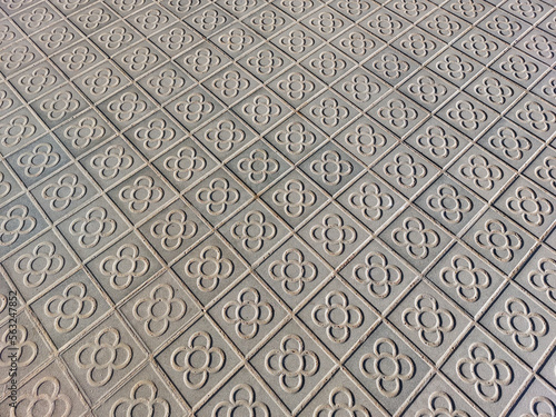 Pavement in Barcelona made of small tiles with the traditional pattern "flower of Barcelona" (la flor de Barcelona)
