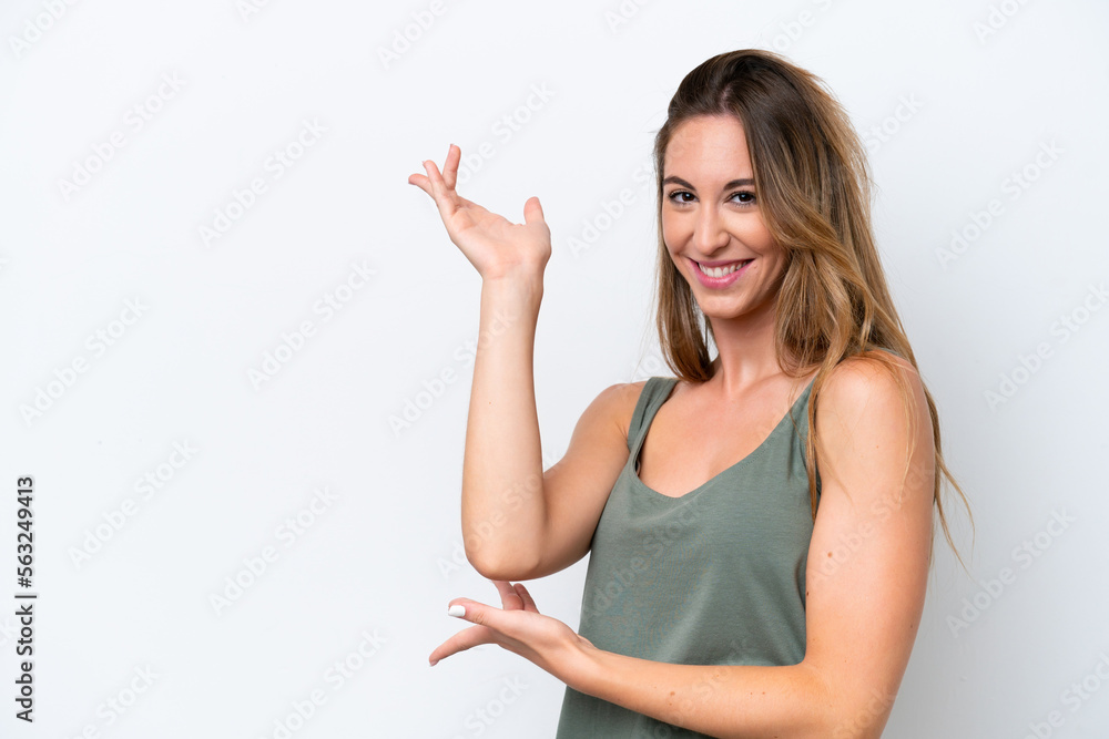 Young caucasian woman isolated on white background extending hands to the side for inviting to come Young caucasian woman isolated on white background extending hands to the side for inviting to come