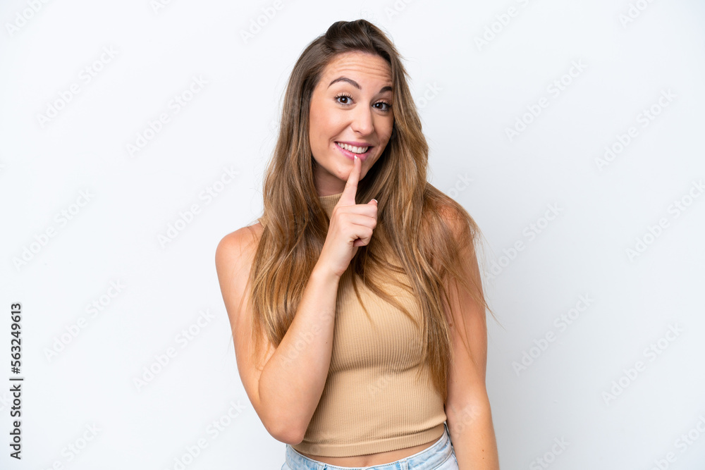 Young caucasian woman isolated on white background showing a sign of silence gesture putting finger in mouth Young caucasian woman isolated on white background showing a sign of silence gesture putting finger in mouth