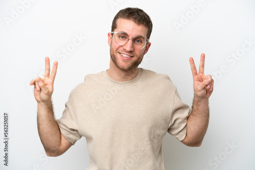 Young caucasian man isolated on white background showing victory sign with both hands