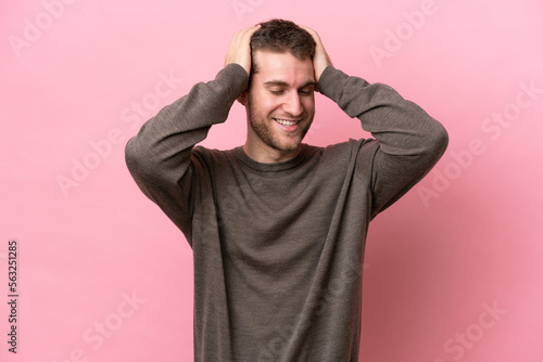 Young caucasian man isolated on pink background laughing © luismolinero