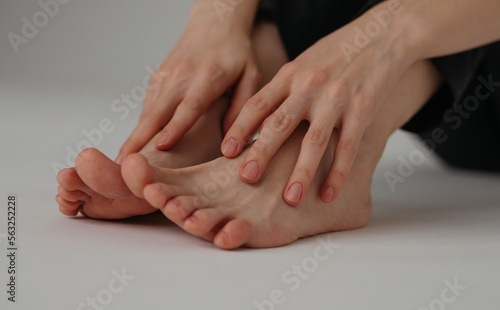 Woman s hands lying on her feet