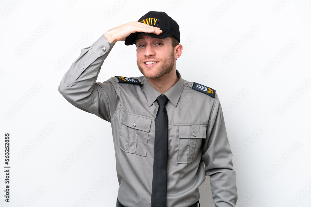 Young safeguard caucasian man isolated on white background looking far away with hand to look something Young safeguard caucasian man isolated on white background looking far away with hand to look something