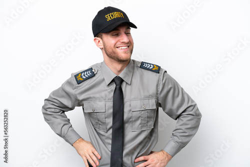 Young safeguard caucasian man isolated on white background posing with arms at hip and smiling © luismolinero