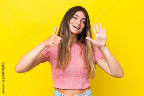 Young caucasian woman isolated on yellow background counting six with fingers