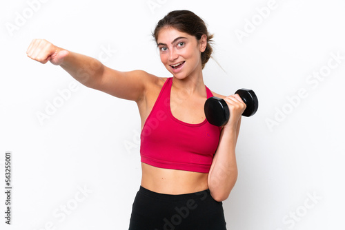 Young sport caucasian woman making weightlifting isolated on white background giving a thumbs up gesture © luismolinero