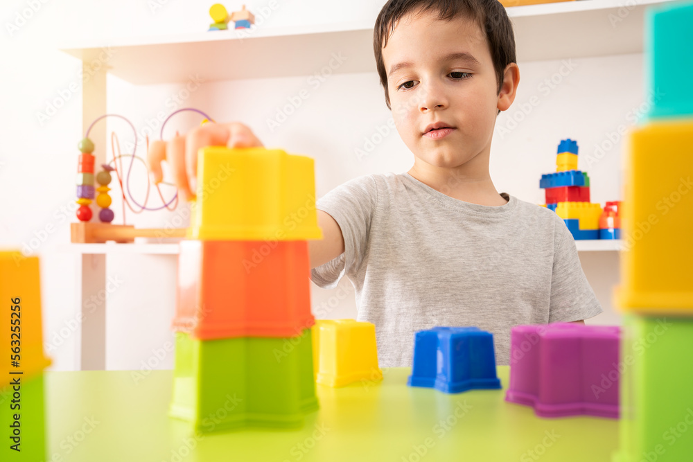An interested pre-school child building something with plastic blocks. An interested pre-school child building something with plastic blocks.