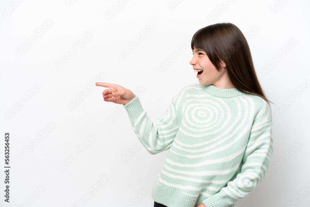 Little caucasian girl isolated on white background pointing finger to the side and presenting a product Little caucasian girl isolated on white background pointing finger to the side and presenting a product