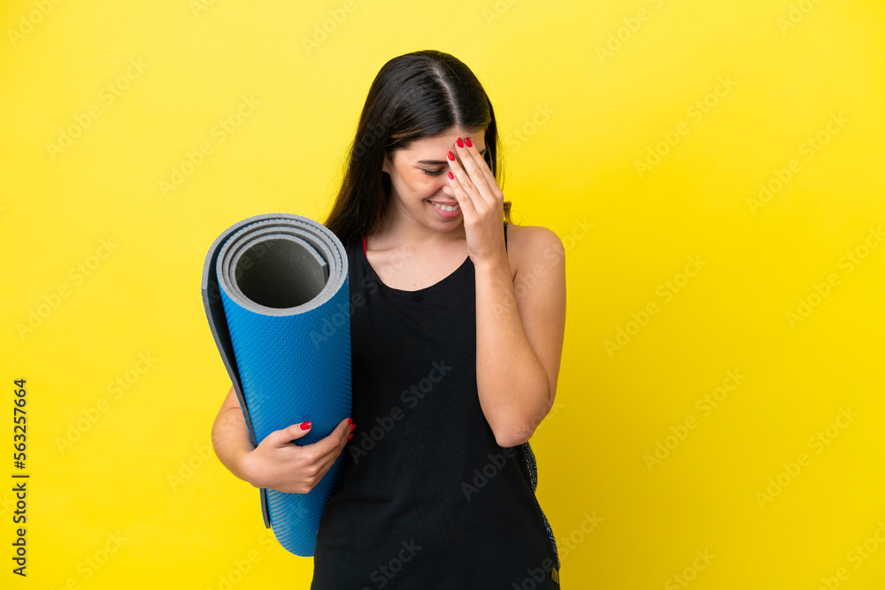 sport Italian woman going to yoga classes isolated on yellow background laughing sport Italian woman going to yoga classes isolated on yellow background laughing