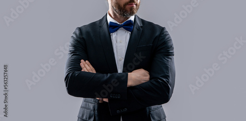 formal tuxedo man in studio. cropped photo of man wearing formal tuxedo.