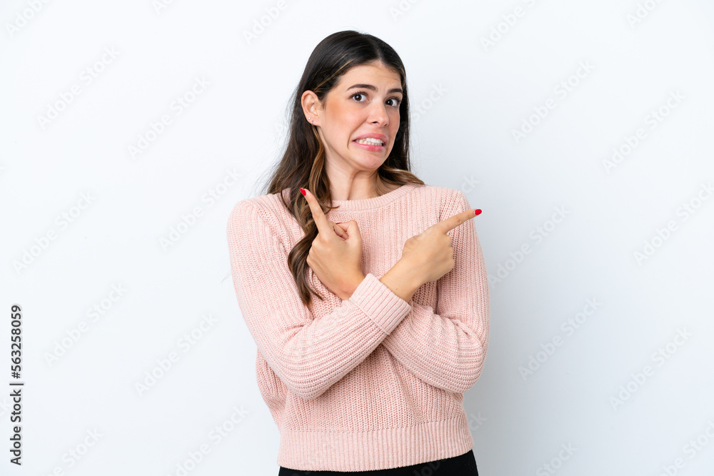 Young Italian woman isolated on white background pointing to the laterals having doubts Young Italian woman isolated on white background pointing to the laterals having doubts