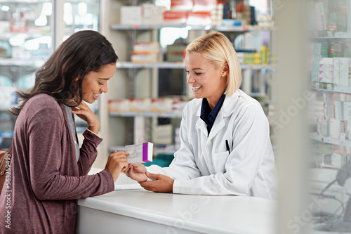 Happy, customer and pharmacist with healthcare medicine assistance, help and expertise at store counter. Advice and opinion of worker helping girl with medication information at pharmacy.