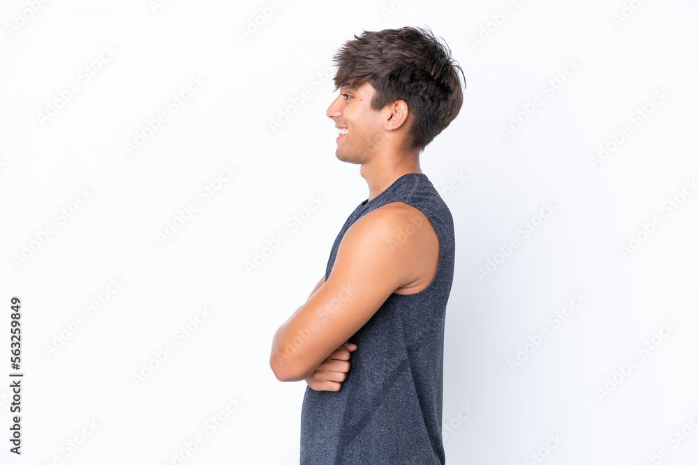 Young sport caucasian man isolated on white background in lateral position Young sport caucasian man isolated on white background in lateral position