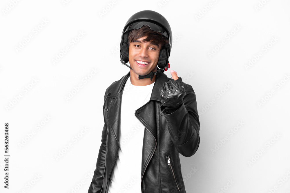 Young man with a motorcycle helmet isolated on white background making money gesture Young man with a motorcycle helmet isolated on white background making money gesture