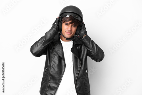 Young man with a motorcycle helmet isolated on white background frustrated and covering ears © luismolinero