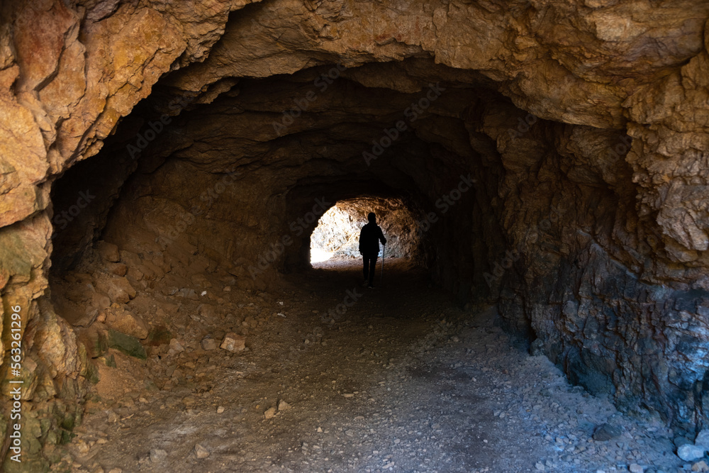 Woman trekking in a cave along to the caminos de Ronda in Catalonia Spain