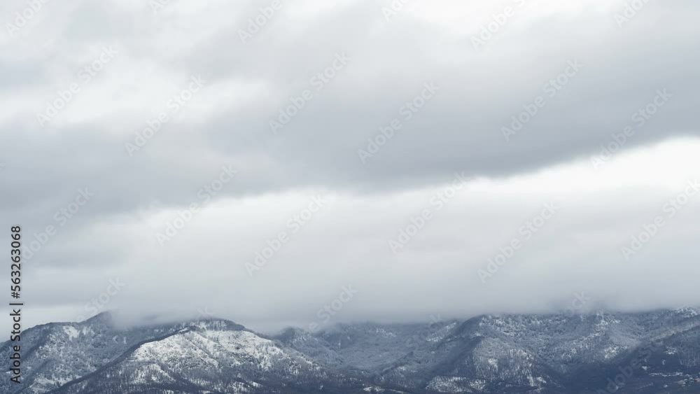 Snowy storm clouds motion over winter mountain profile timelapse,cold season weather 4k Snowy storm clouds motion over winter mountain profile timelapse,cold season weather 4k