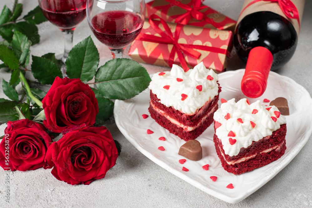 Cakes Red velvet in the shape of hearts with whipped cream on white plate, roses and bottle wine for Valentines Day Cakes Red velvet in the shape of hearts with whipped cream on white plate, roses and bottle wine for Valentines Day