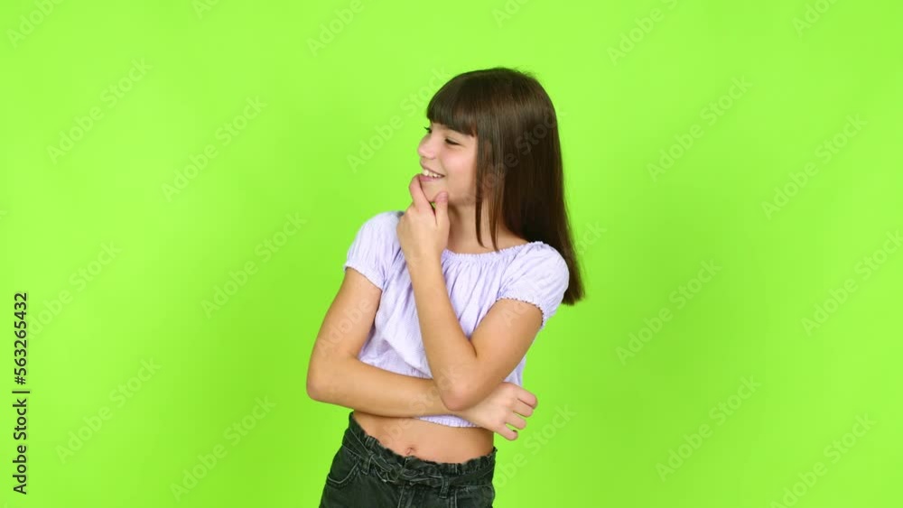 Little girl standing and looking to the side over isolated background Little girl standing and looking to the side over isolated background