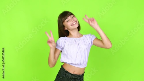 Little girl smiling and showing victory sign with a cheerful face over isolated background