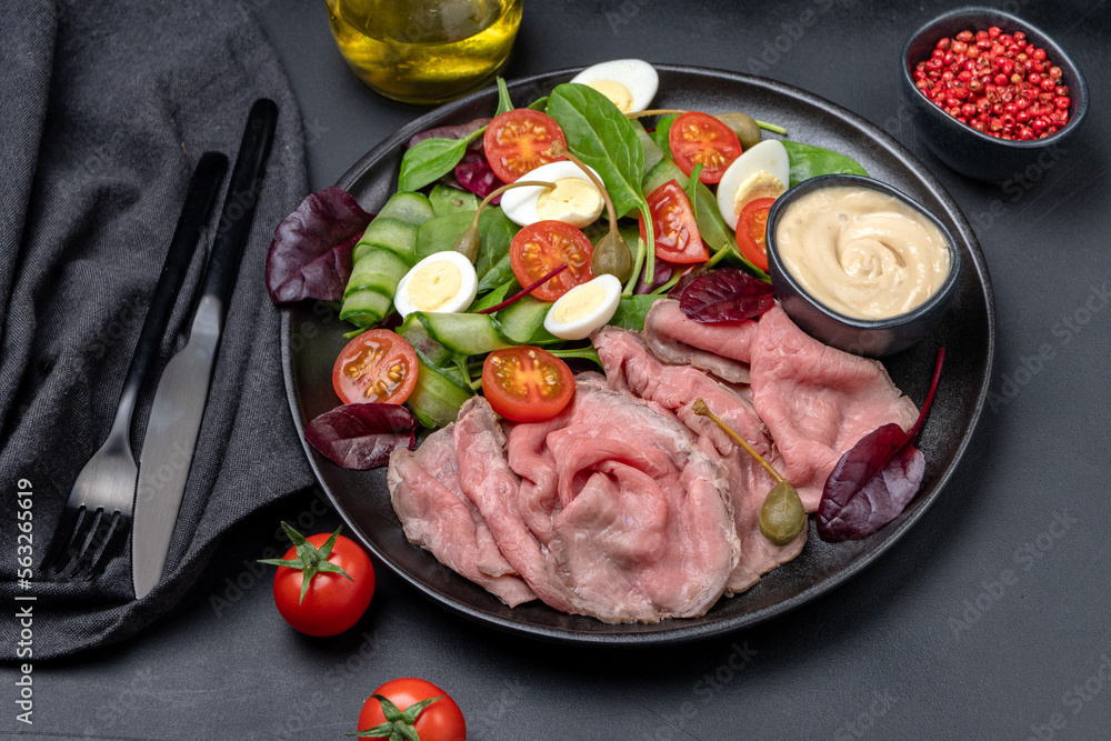 Lunch dish Roast beef with spinach salad and quail eggs healthy lunch keto diet food	