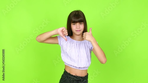 Little girl making good-bad sign over isolated background