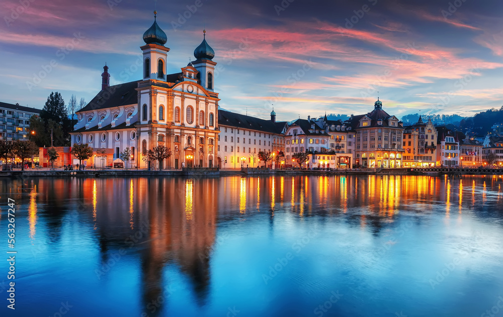 Colorful evening view of the Old Town medieval architecture in Lucerne, Switzerland. Dramatic scene with Reuss river, Jesuit church. Wonderful vivid cityscape during sunset. popular travel destination