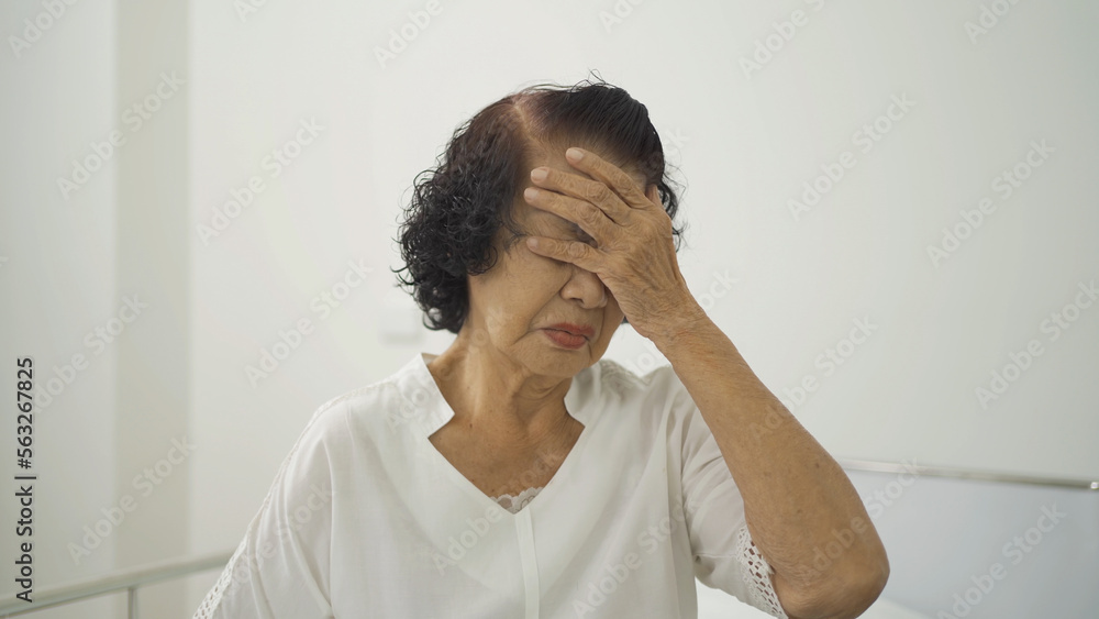 Sick depressed lonely Asian old elderly senior patient or pensioner. People sitting on bed in bedroom at nursing home. Quarantine lifestyle. Unhappy life. Retirement community. Health care. Alone Sick depressed lonely Asian old elderly senior patient or pensioner. People sitting on bed in bedroom at nursing home. Quarantine lifestyle. Unhappy life. Retirement community. Health care. Alone