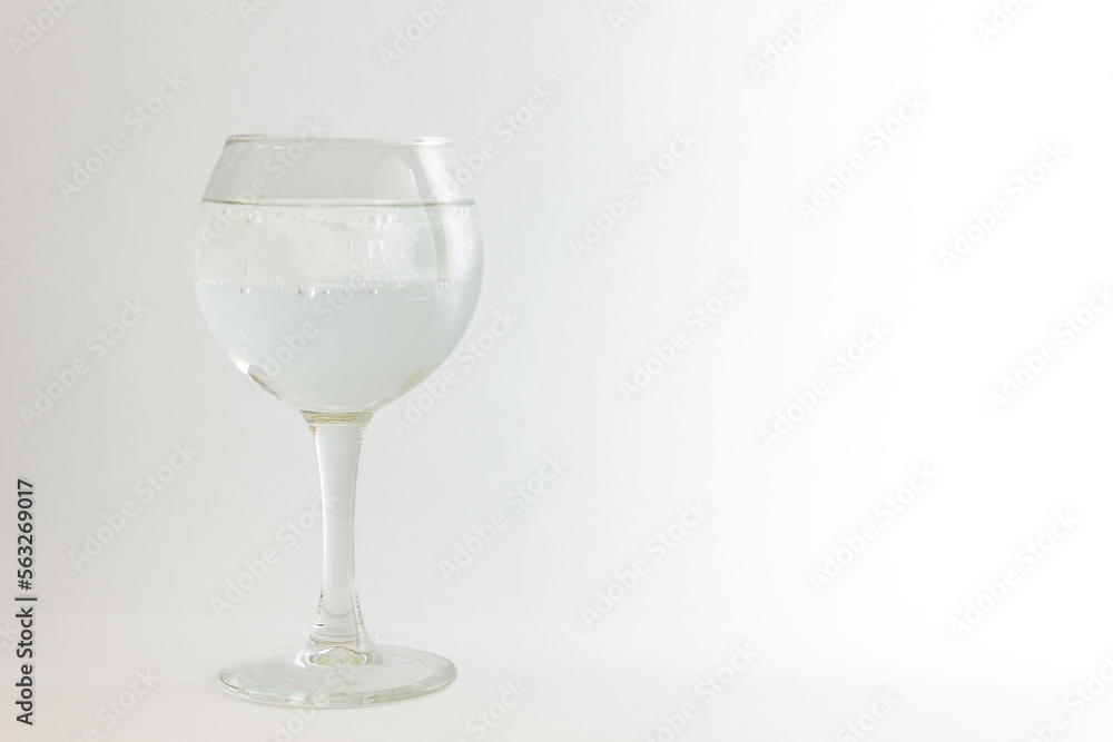 Glass with mineral water on a white background. Glass with mineral water on a white background.
