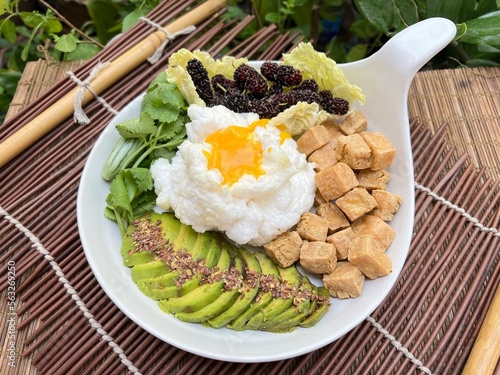 Avocado with fried egg tofu and vegetable photo