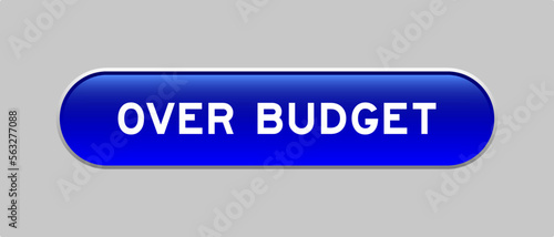 Blue color capsule shape button with word over budget on gray background photo