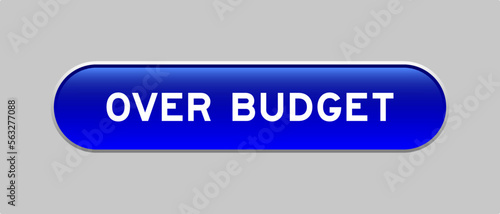Blue color capsule shape button with word over budget on gray background