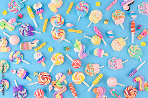 Background of decorative sweets, lollipops and ice cream. Top view on blue background