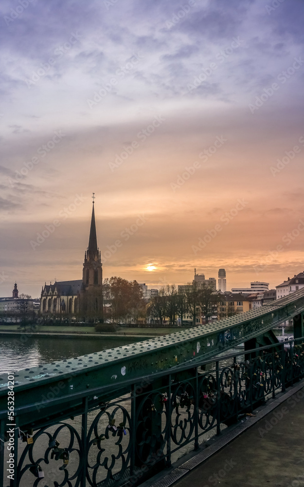 Naklejka premium Sunrise over a church in frankfurt
