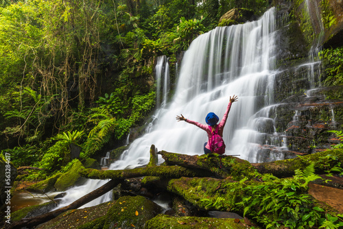 Young woman hiking on beautiful waterfall in Phu Hin Rong Kla National Park, Phitsanulok  province, ThaiLand. photo