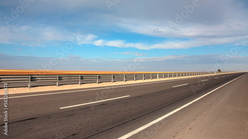 Foto Empty asphalt road with asymmetrical clouds - Nature landscape