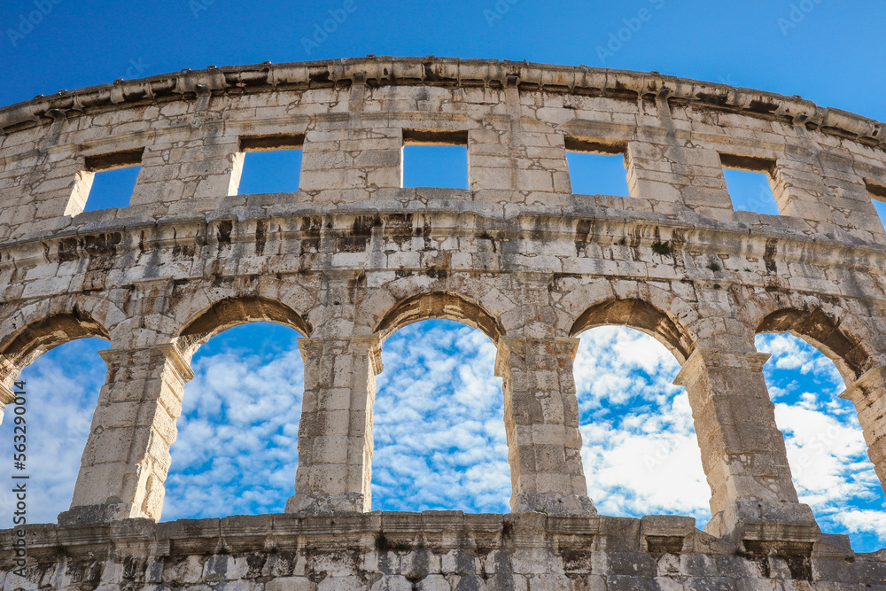 Below View of Pula Arena in Croatia. Beautiful Famous Monument Roman Amphitheatre in Istria with Blue Sky with Clouds during Summer Day.