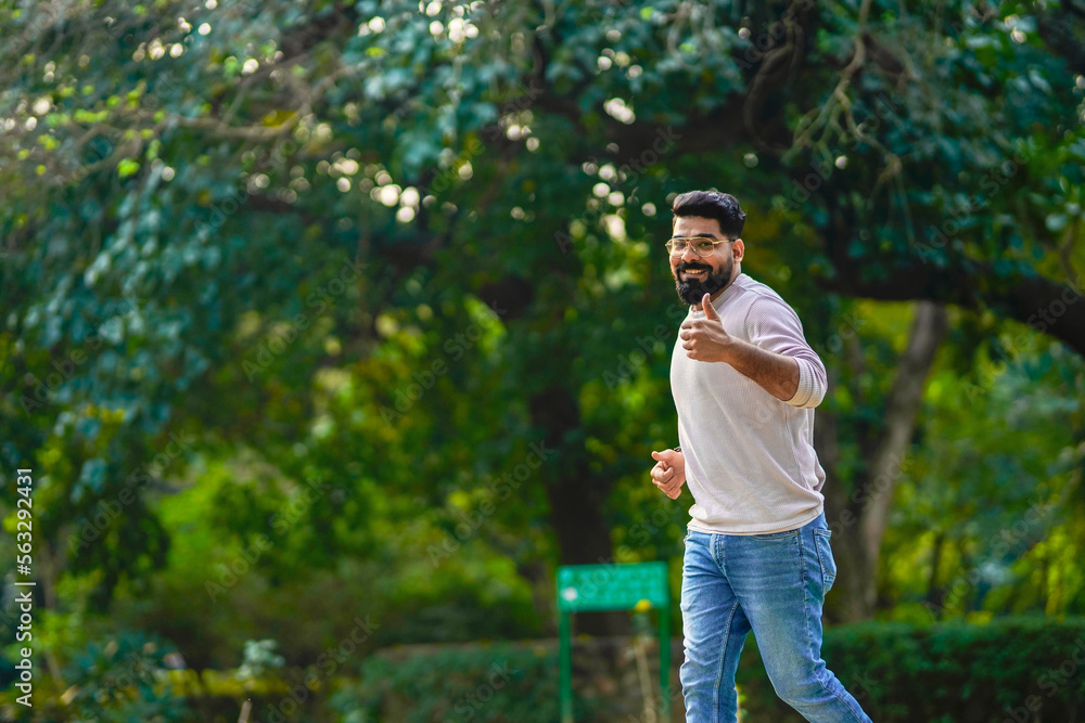 Young indian man running or jogging at park. Young indian man running or jogging at park.