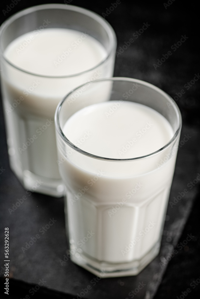 A glass of fresh milk on a stone board. A glass of fresh milk on a stone board.