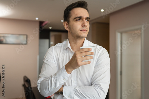 one man wear white shirt with cup of coffee at home hotel or apartment