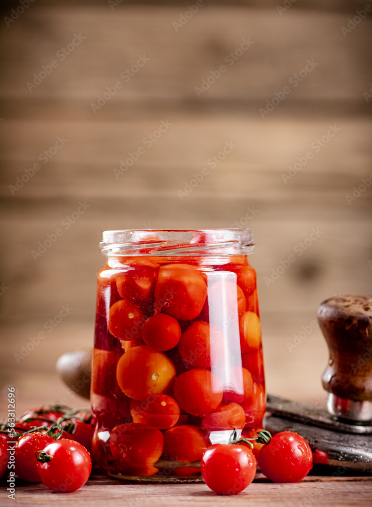 Pickled ripe tomatoes in a glass jar. Pickled ripe tomatoes in a glass jar.