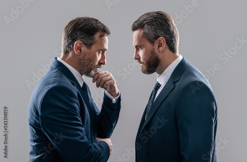 confrontation of two businessmen in suit. photo of businessmen has confrontation look