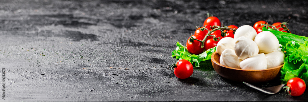 Mozzarella cheese with cherry tomatoes and lettuce. Mozzarella cheese with cherry tomatoes and lettuce.