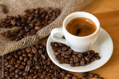 a mug of invigorating espresso in coffee beans