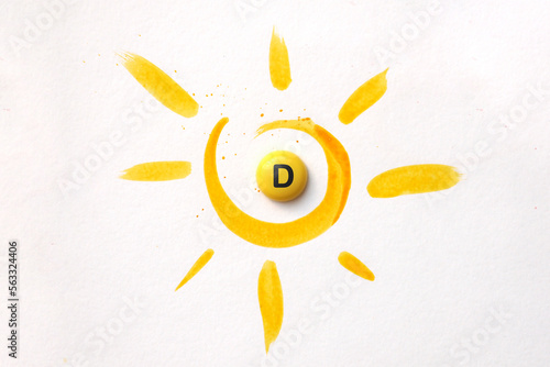 A tablet with the inscription Vitamin D in the center of the sun