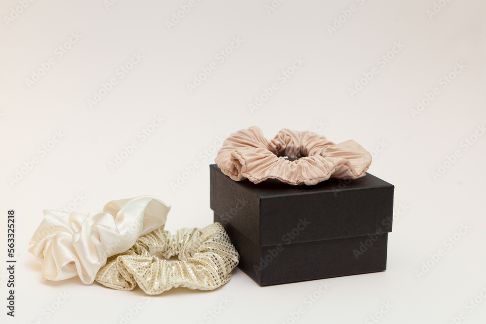 Obraz premium gift box with beige silk scrunchies. lot or hair ties. Luxury tools for ladies. perfect for all hair